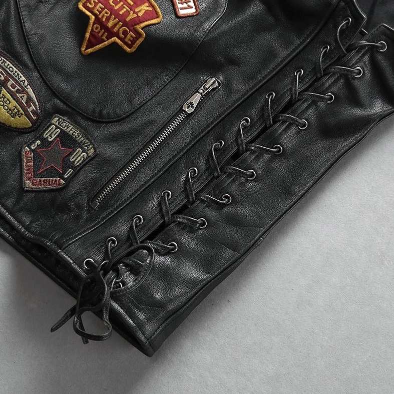 Black genuine cowhide leather biker vest side lace-up panel showing adjustable fit and smooth leather texture