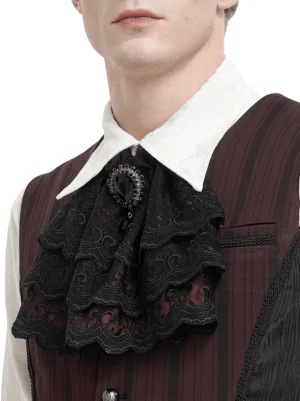 Male model wearing black lace gothic cravat with wine red lining and faux diamond pendant, close-up upper front view