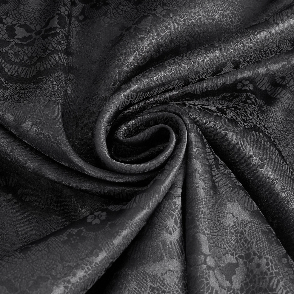 Black lace fabric drape detail of gothic shirt showing intricate floral jacquard weave and soft movement