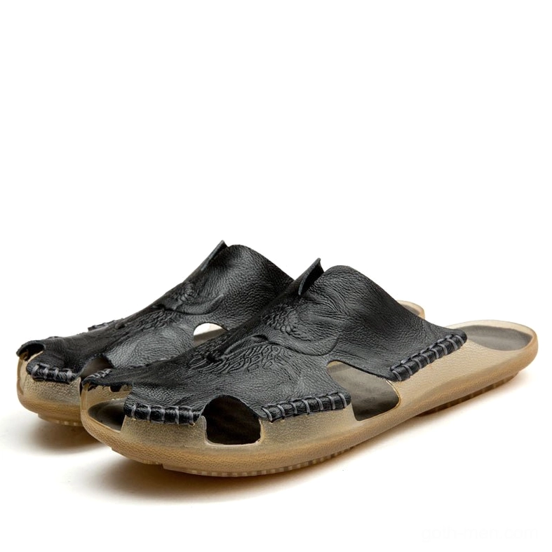 Black split leather gothic slide sandals for men with hand-stitched trim and embossed details, three-quarter view