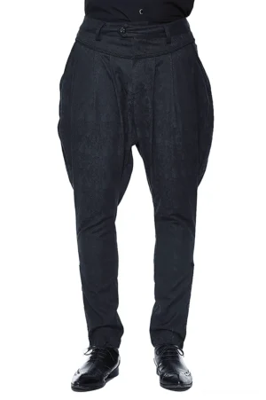 Black gothic pleated harem trousers front full view on male model wearing formal black dress shoes, showing high waist and baggy thigh silhouette with tapered ankle on white background