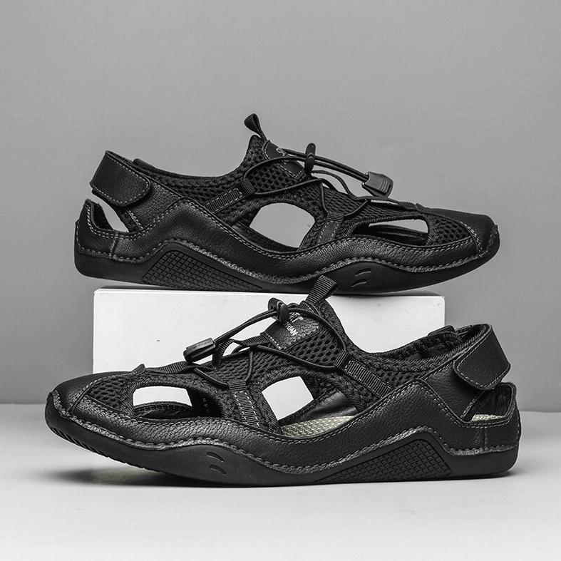 Men's gothic all-black ankle-wrap sandals overhead two-shoe display view on grey display block