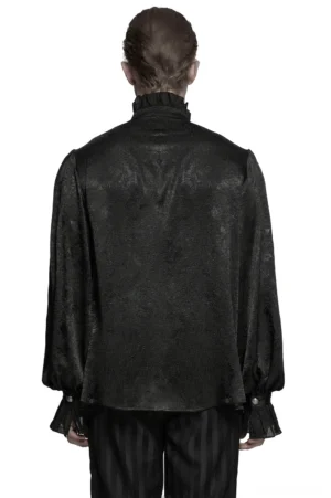 Rear view of male model in Victorian black gothic shirt displaying ruffled cuffs and jacquard fabric