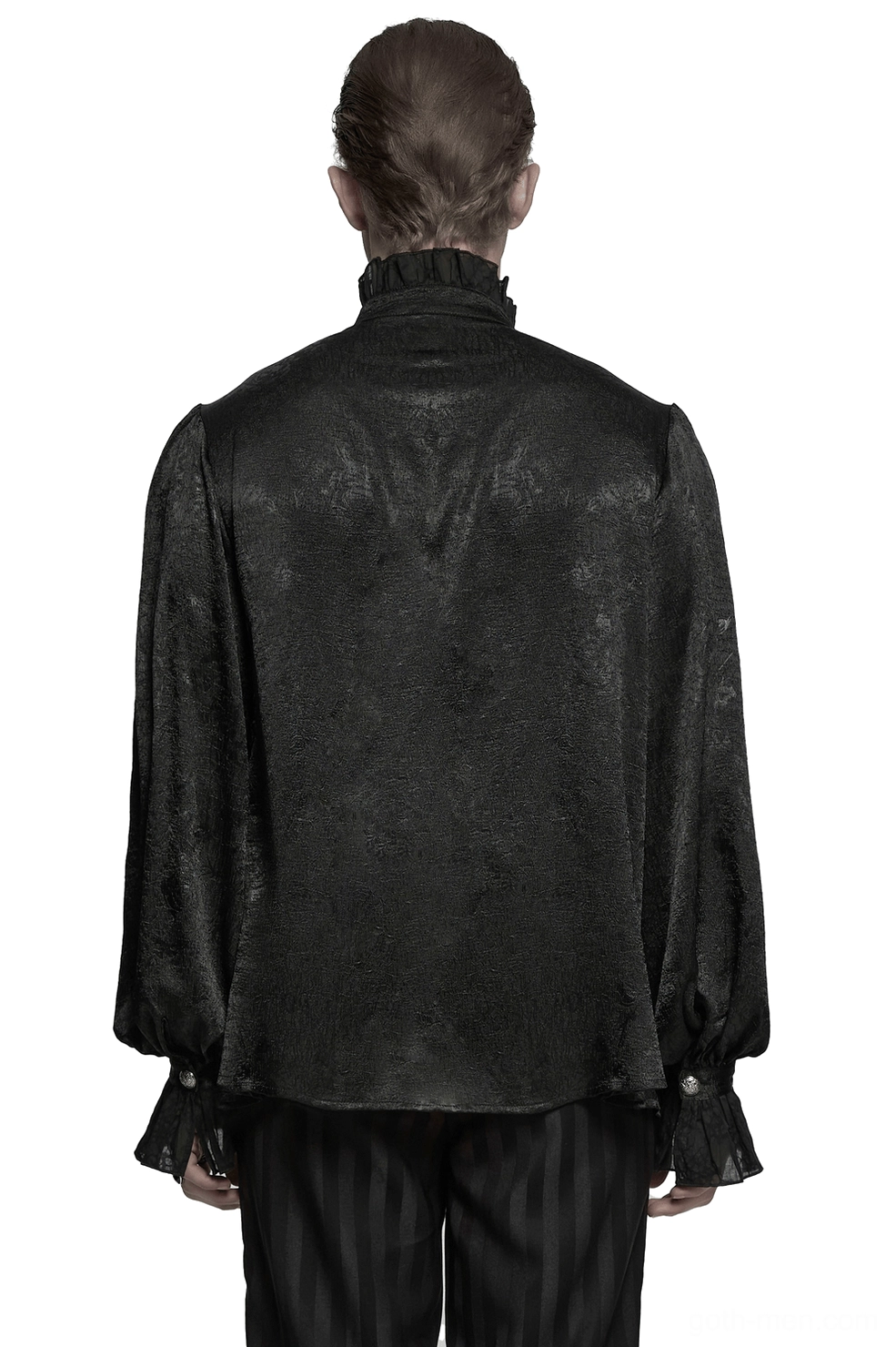 Rear view of male model in Victorian black gothic shirt displaying ruffled cuffs and jacquard fabric
