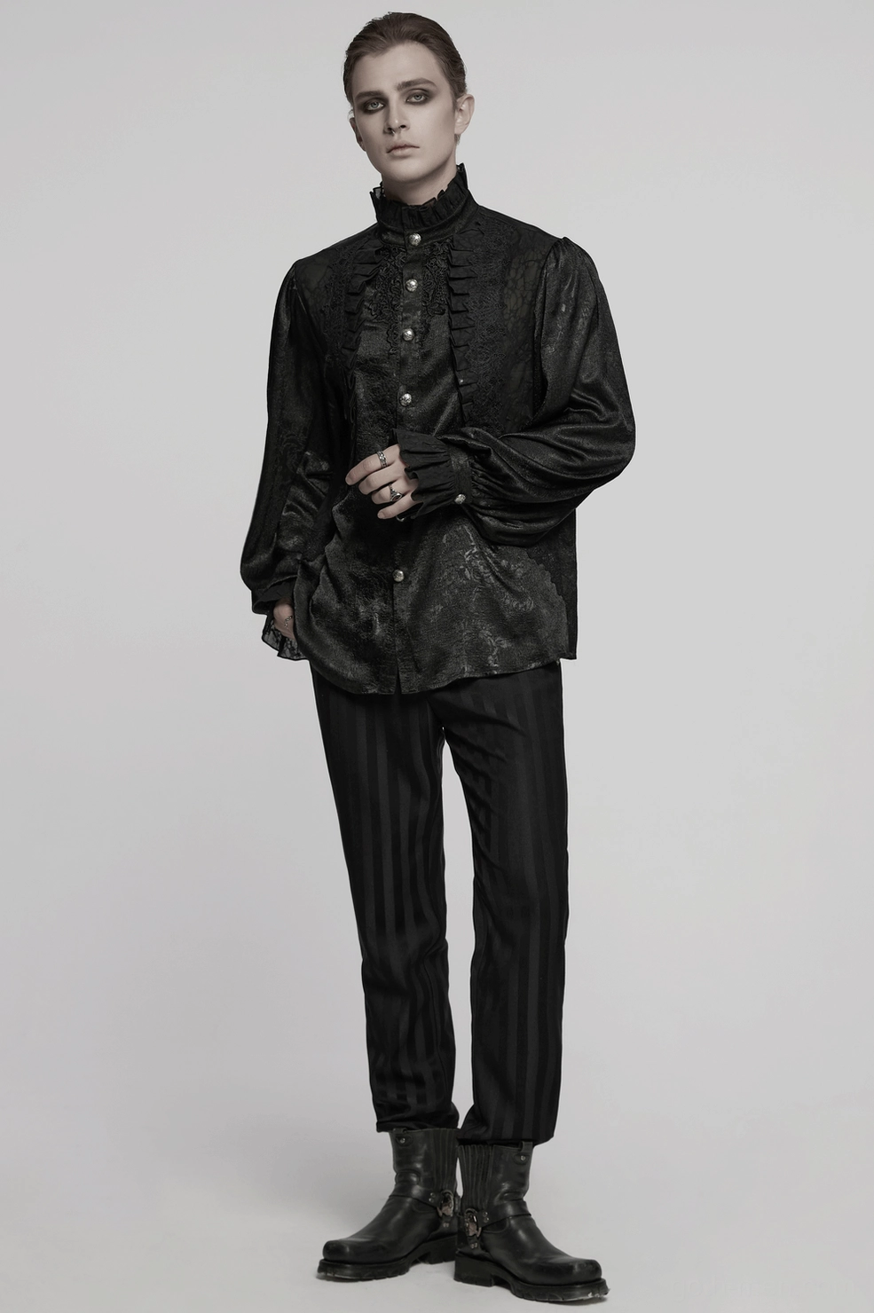 Male model in black Victorian gothic shirt with theatrical ruffles and aristocratic dark aesthetic