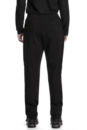 Rear view of gothic black slim pants highlighting high-waist construction and plain back silhouette on male model