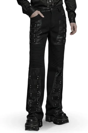 Black gothic wide leg pants with pleated knee panels and rivet straps - front three-quarter view on male model