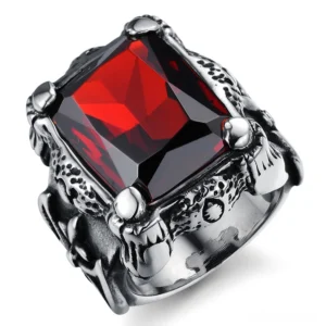 Close-up detail of blood red square zircon ring featuring vintage carved metal texture, emerald-cut gemstone, and intricate cross engravings on Gothic band