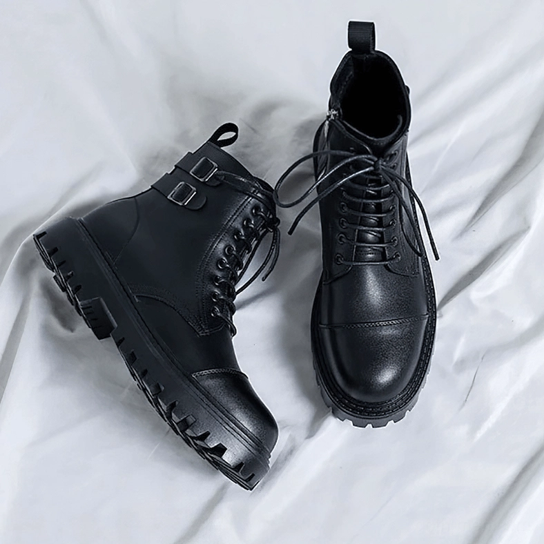 Paired black gothic lace-up ankle boots overhead flat lay view