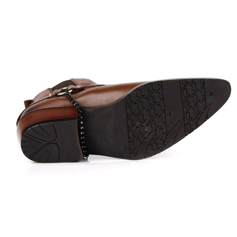 Brown leather gothic boots outsole showing polished finish and chain heel accent