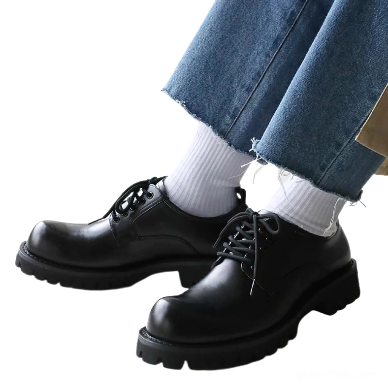 Styled view of gothic platform boots worn with cropped jeans and white socks on feet