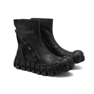 Gothic platform ankle boots with exposed rear zipper hardware and blocky rubber sole detail