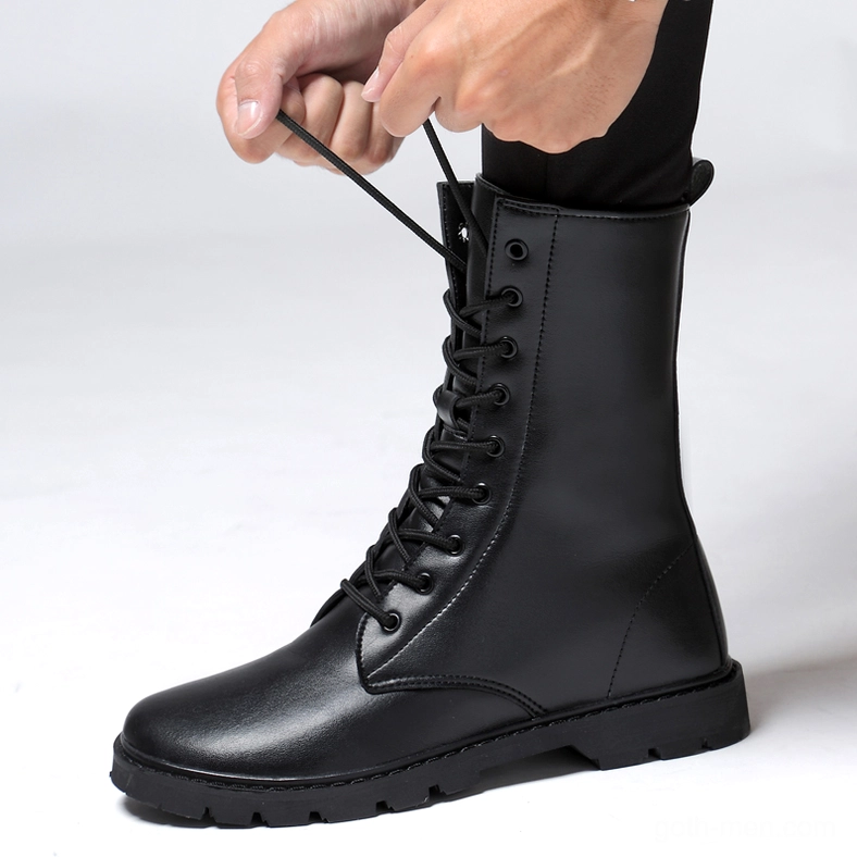 Hands adjusting shoelaces on black gothic combat boots – functional lace-up closure detail