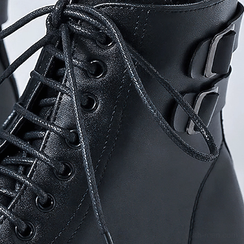 Close-up of gothic boot lacing system with metal buckles and waxed laces