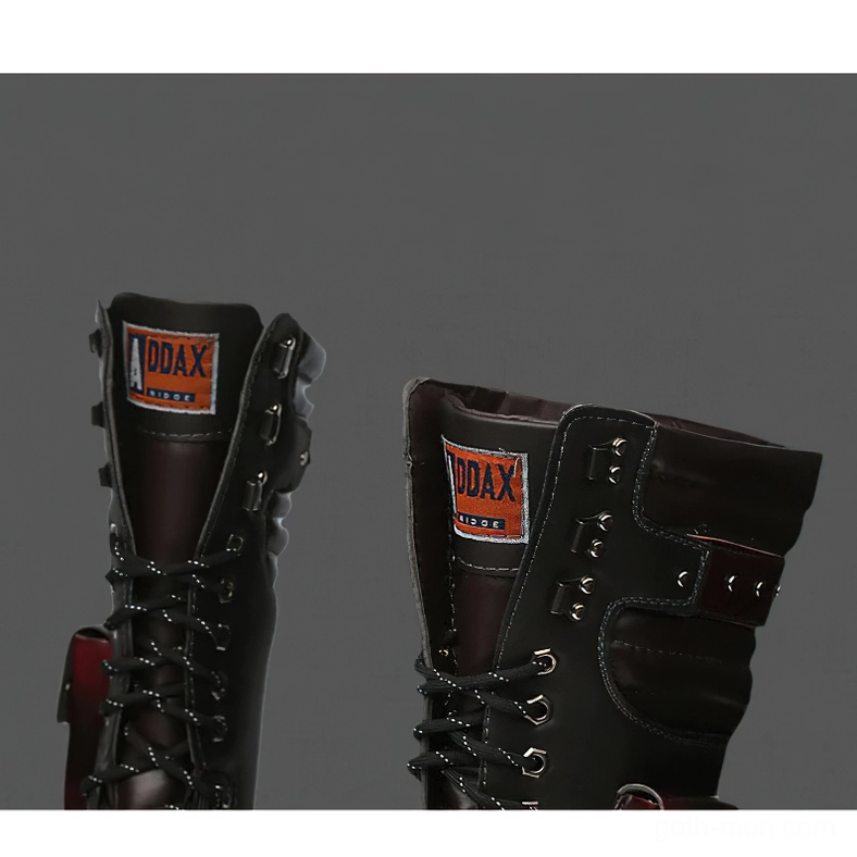 Close-up detail of gothic boots showing branded collar tag and premium leather texture - dark background