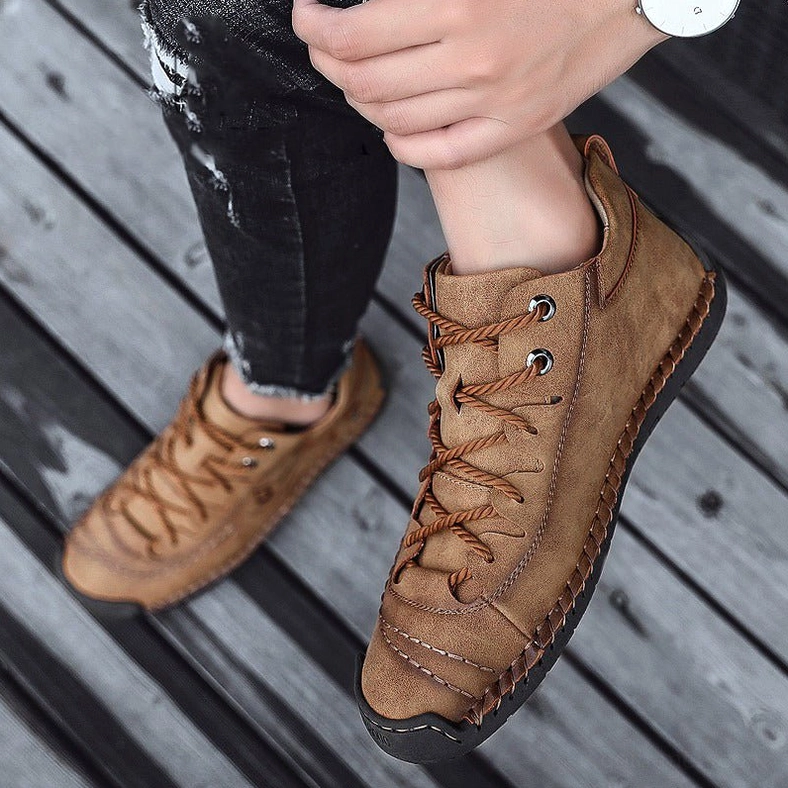 Close-up detail of gothic boot leather texture and hand-stitching showing authentic craftsmanship quality