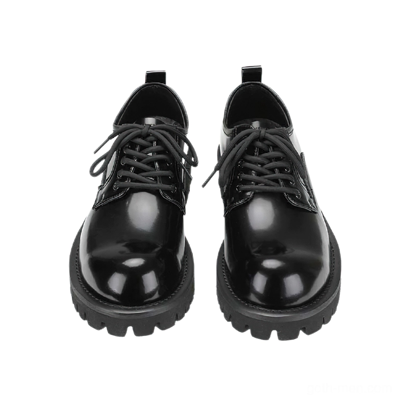 Overhead view of black gothic platform derby boots with symmetrical lace-up design and patent leather