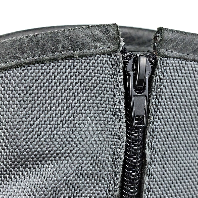 Boot zipper and woven textile ankle fabric close-up with leather trim stitching