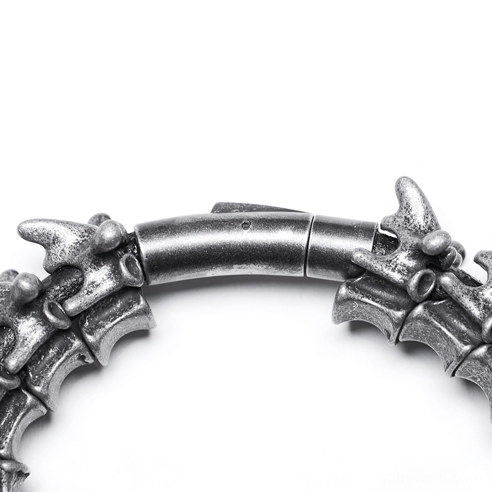 Close-up macro shot of vertebra spike bracelet clasp mechanism with aged silver texture