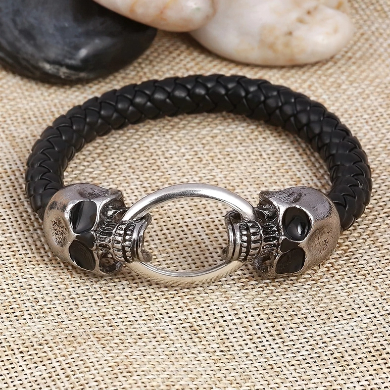 Gothic leather bracelet with silver skull and dragon head clasps - detailed close-up of metal hardware and craftsmanship
