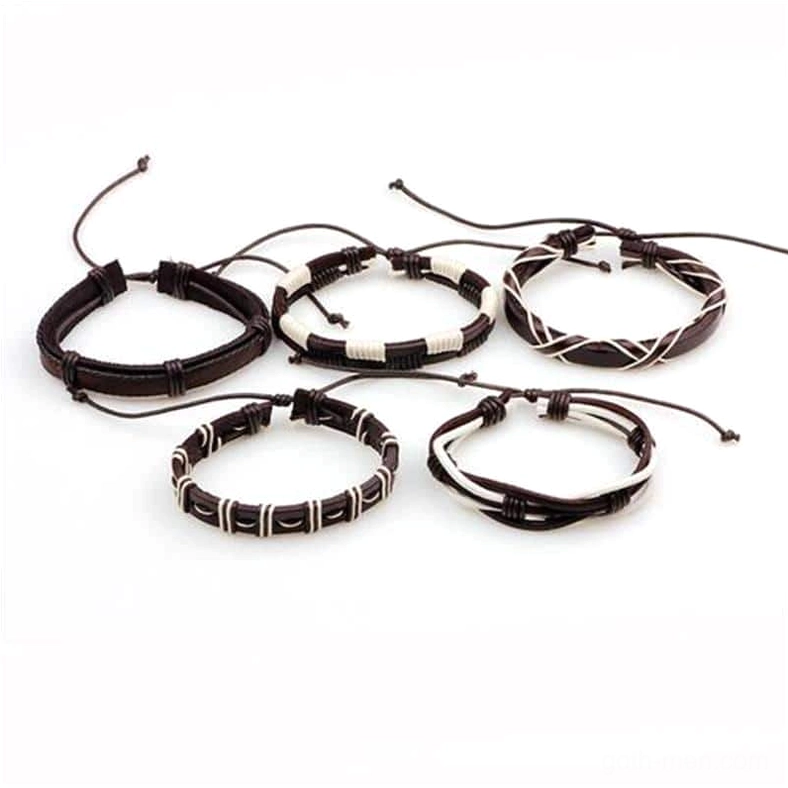 Top-down view of minimalist circular gothic leather bracelets with adjustable drawstring closures, black and white woven leather composition