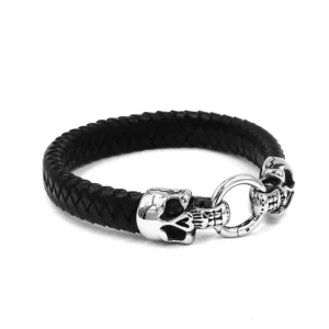Black braided leather biker bracelet with silver skull accents and round connecting ring, side perspective