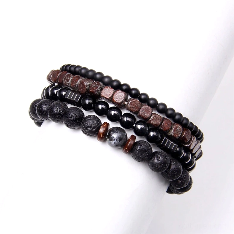 Gothic stone and wood beaded bracelet stack worn on white mannequin arm - multi-layer natural material jewelry display
