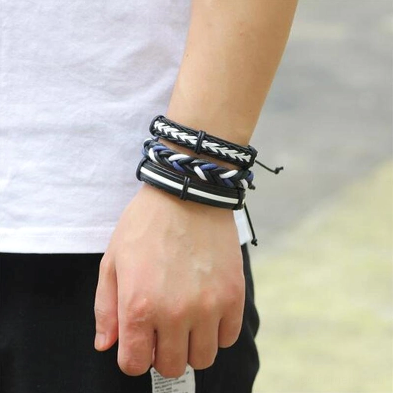 Alternative dark fashion bracelet layering with blue braided rope details on male wrist