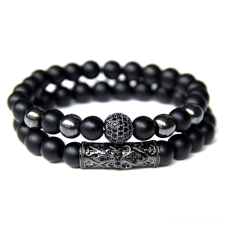 Gothic-inspired beaded bracelet with single tiger's eye stone focal point and mixed black bead styles with carved metal decor