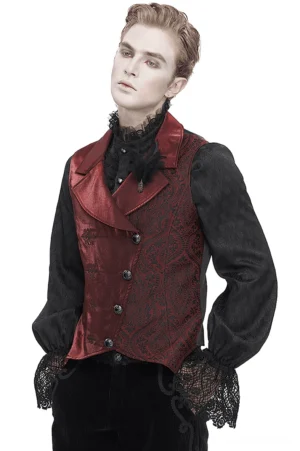 Male model wearing wine red gothic brocade waistcoat with feather brooch and black lace shirt, front three-quarter view against white studio background