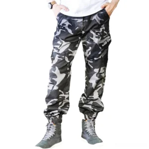 Camouflage gothic cargo pants front view on male model, oversized military style with side pockets
