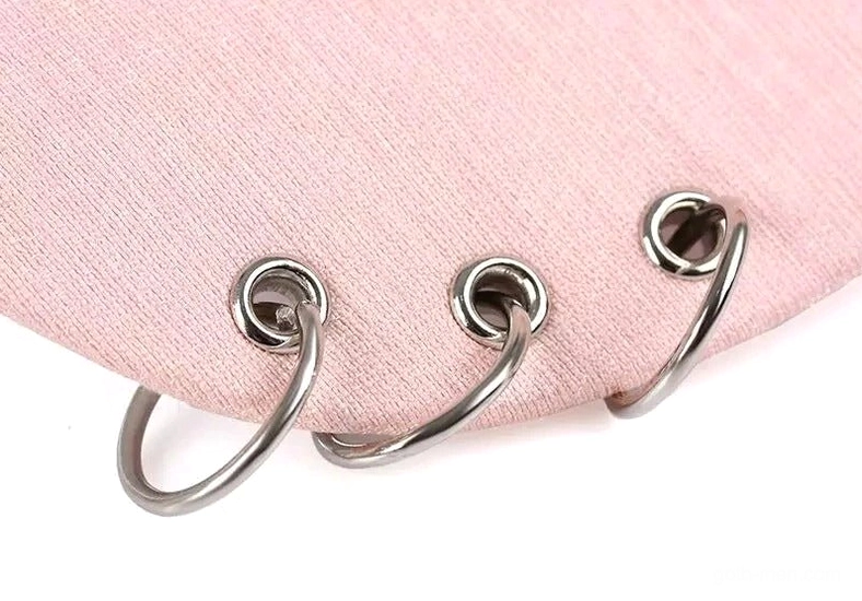 Close-up of metal hoop ring decorations on brim of gothic baseball cap
