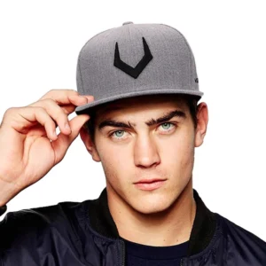 Gothic 3D embroidered baseball cap in grey with black V symbol, worn by male model in studio setting, front close-up view