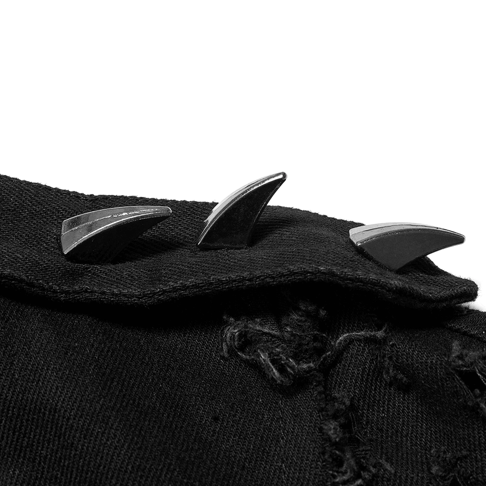 Close-up of black notched lapel with metal spike accents and distressed frayed texture on gothic cape