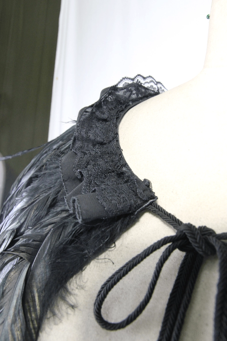 Steampunk gothic cape side detail close-up drawstring cord feathered base fabric layered design