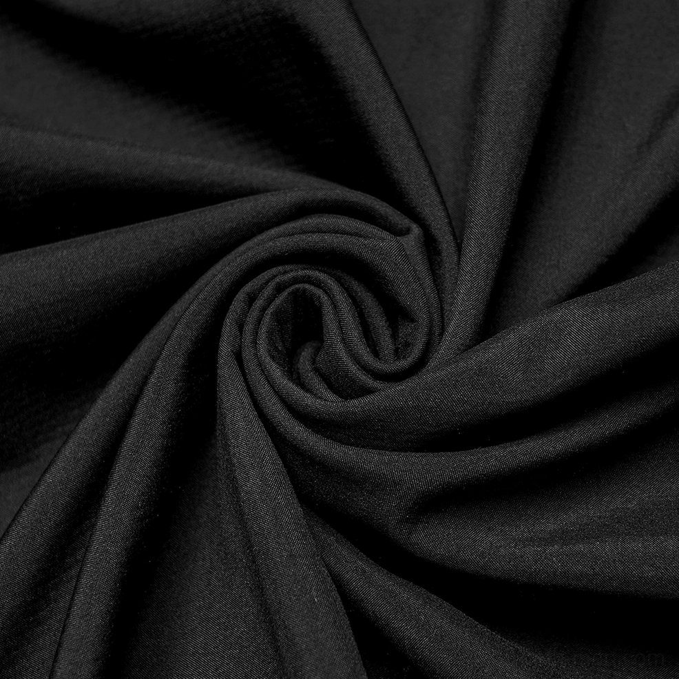 Side zipper closure detail on waterproof gothic cape featuring silver metal slider, matte black textile, and technical construction