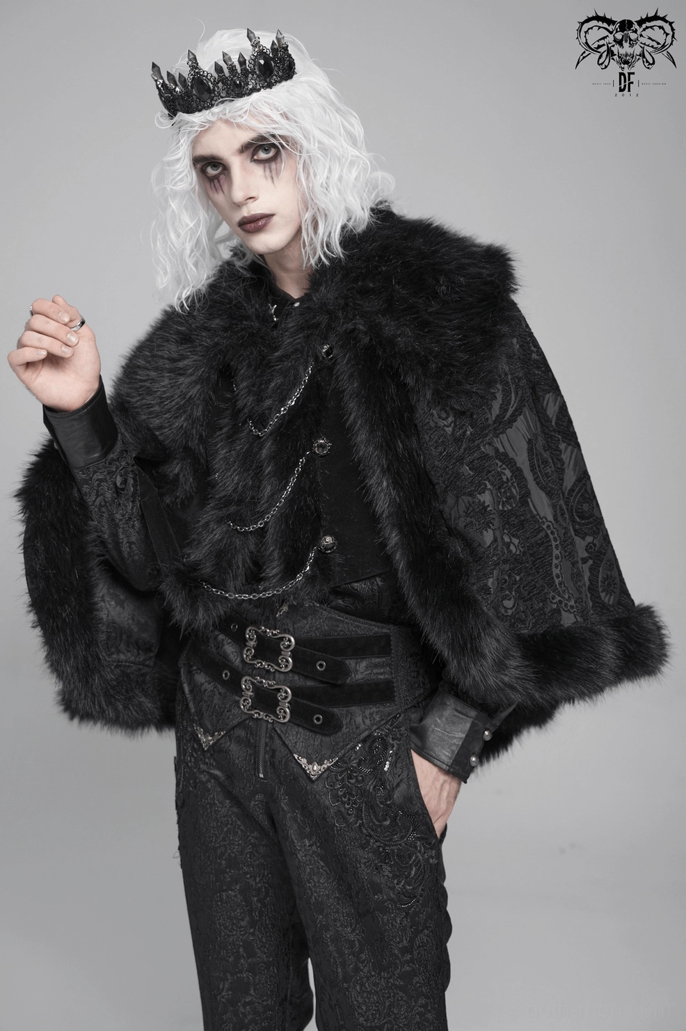 Black gothic cape displayed showing flowing sleeve construction and decorative metal chain hardware on model