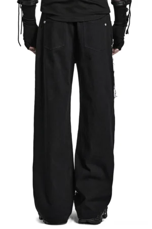Black gothic cargo pants back full-body view on model, featuring wide leg cut and patch pocket details from rear angle
