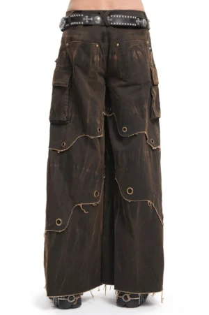 Brown distressed wide leg pants back view showing cargo pockets and metal grommets on male model