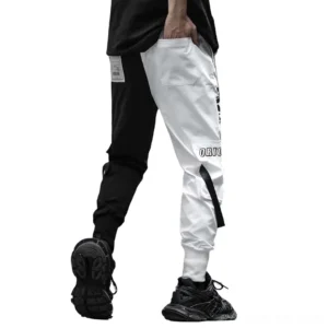 Back view of black and white color-block cargo trousers showing split design and patch details