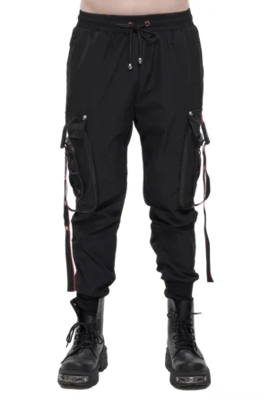 Men's black gothic cargo trousers with red accent straps worn by model - front full view