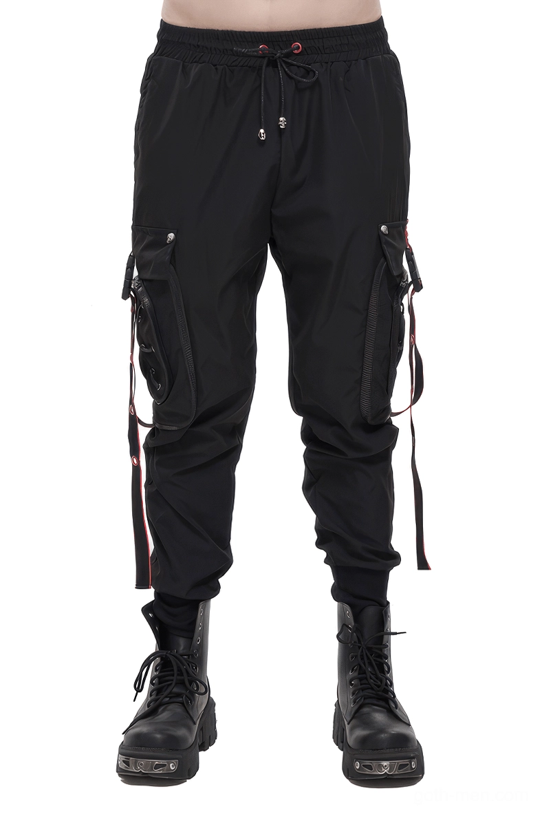 Men's black gothic cargo trousers with red accent straps worn by model - front full view