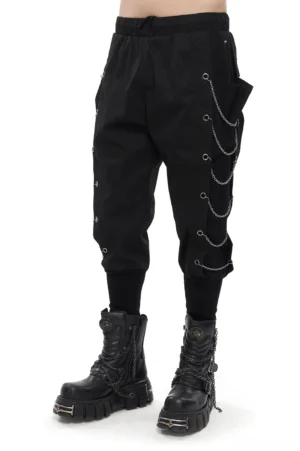 Black gothic cargo pants with metal chain eyelets, worn with platform combat boots, three-quarter side view showing loose fit and tapered cuffs