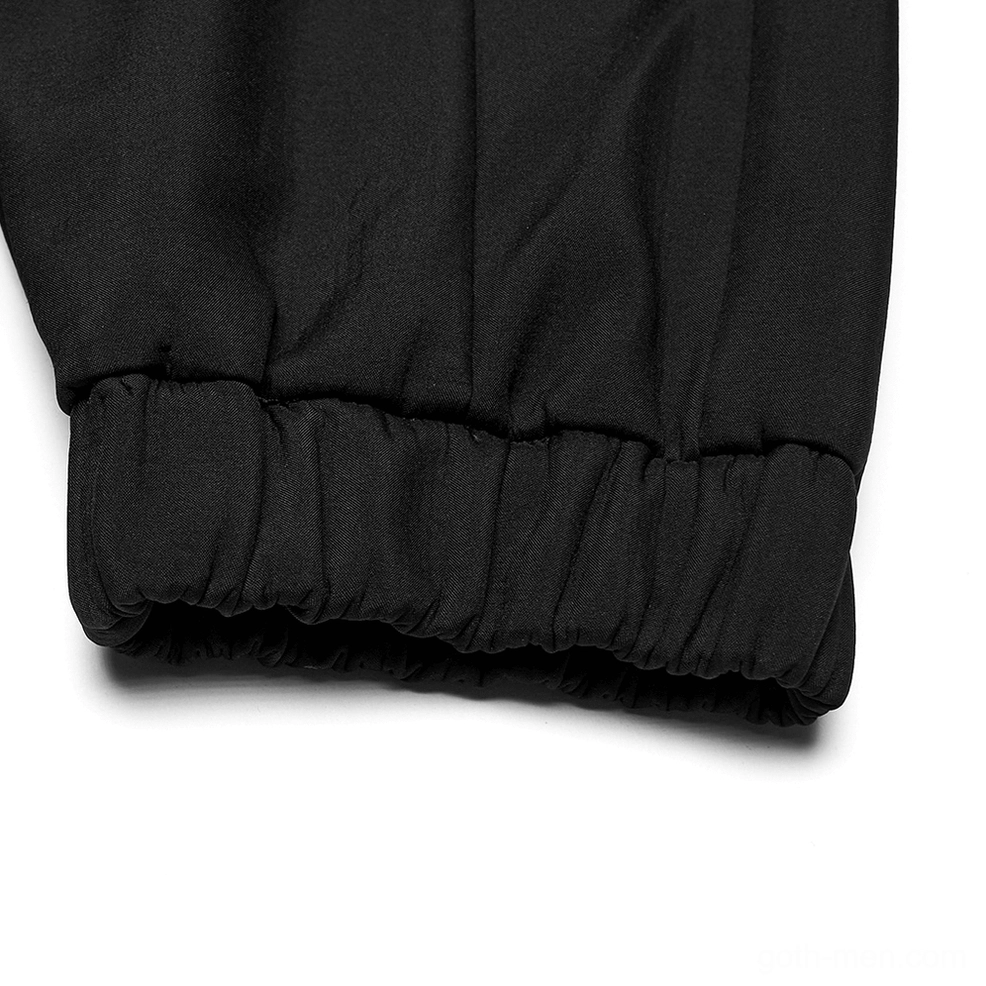 Close-up detail of black gothic cargo pants elastic gathered hem and woven fabric texture