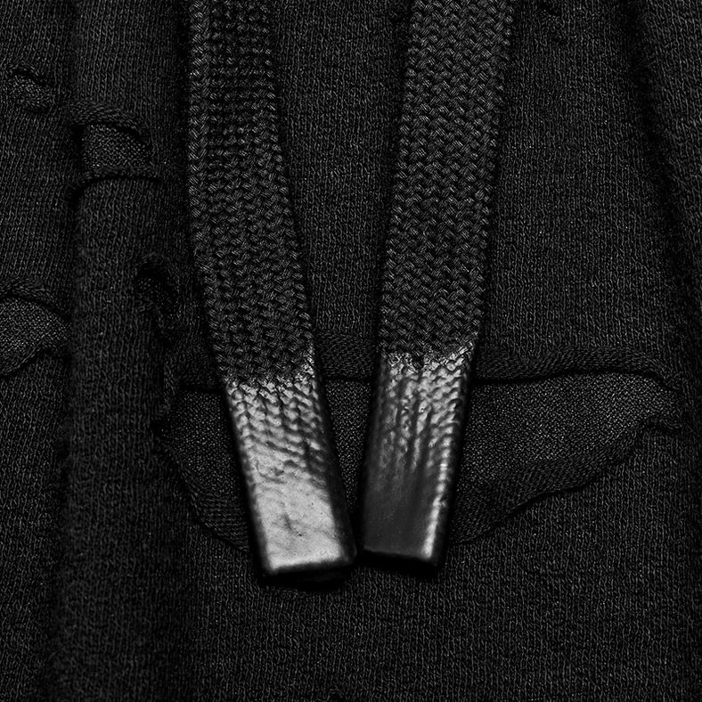 Black gothic harem pants leather-tipped drawstring close-up showing knitted fabric construction