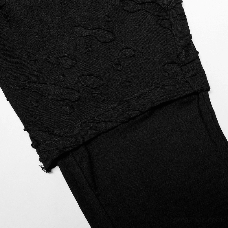 Black gothic pants distressed perforated fabric close-up texture with layered hem design detail