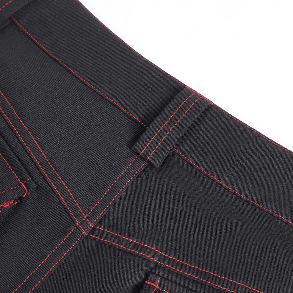 Industrial gothic cargo pants fabric texture showing heavy twill weave and red topstitching craftsmanship