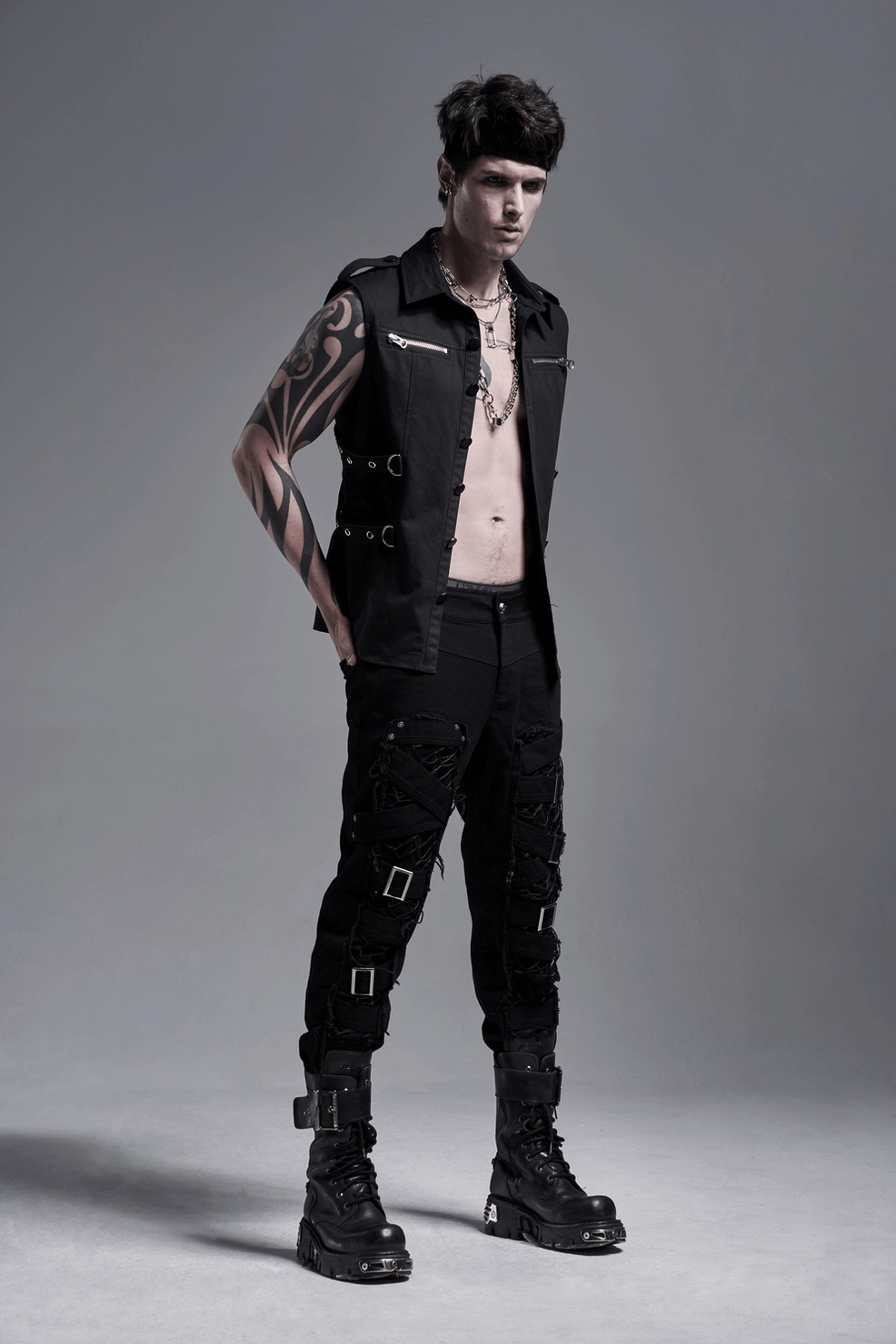Black gothic cargo pants worn detail showing fitted silhouette and mesh front panel transparency