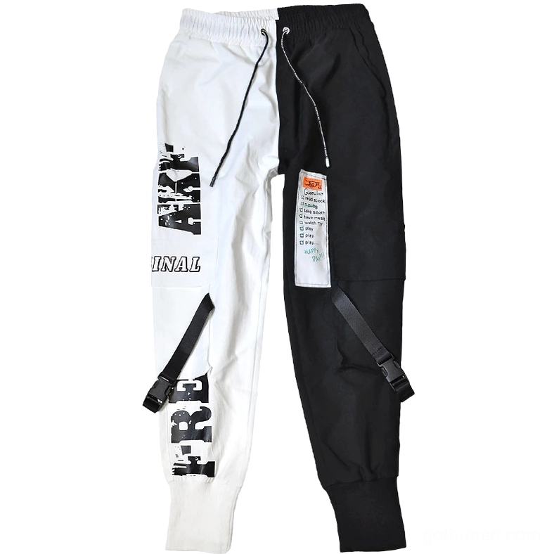 Flat lay overhead shot of black and white patchwork cargo pants displaying drawstring waist and pocket design