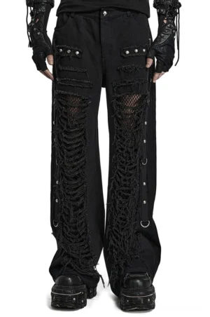 Black distressed gothic cargo pants with lace-up chain details worn by male model, front full-body view showcasing ripped fishnet panels and studded pocket design